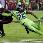 Seattle Seahawks cornerback Richard Sherman (25) tackles Arizona Cardinals wide receiver John Brown (12) during the second half of an NFL football game against the Arizona Cardinals, Thursday, Nov. 9, 2017, in Glendale, Ariz. Sherman walked to the bench after being injured on the play. (AP Photo/Rick Scuteri)