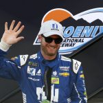 Dale Earnhardt Jr. smiles as he waves to cheering fans during driver introductions prior to a NASCAR Cup Series auto race at Phoenix International Raceway Sunday, Nov. 12, 2017, in Avondale, Ariz. (AP Photo/Ross D. Franklin)