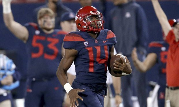 Arizona quarterback Khalil Tate (14) cruises into the end zone at the end of a long run against Ore...