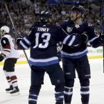 Winnipeg Jets' Brandon Tanev (13) and Andrew Copp (9) celebrate after Copp scored against the Arizona Coyotes during first period NHL hockey action in Winnipeg, Manitoba, Tuesday, Nov. 14, 2017. (Trevor Hagan/The Canadian Press via AP)