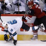 Arizona Coyotes defenseman Luke Schenn (2) checks San Jose Sharks right wing Kevin Labanc (62) into the boards during the second period of an NHL hockey game Wednesday, Nov. 22, 2017, in Glendale, Ariz. (AP Photo/Ross D. Franklin)