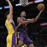 Phoenix Suns forward TJ Warren, right, shoots as Los Angeles Lakers guard Lonzo Ball defends during the second half of an NBA basketball game, Friday, Nov. 17, 2017, in Los Angeles. The Suns won 122-113. (AP Photo/Mark J. Terrill)
