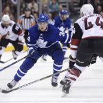 Toronto Maple Leafs center Auston Matthews (34) skates the puck up ice as Arizona Coyotes defenseman Kevin Connauton (44) defends during second period NHL hockey action in Toronto on Monday, Nov. 20, 2017. (Nathan Denette/The Canadian Press via AP)