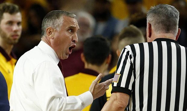 Arizona State head coach Bobby Hurley, left, argues with an official during the first half of an NC...