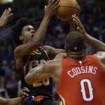 Phoenix Suns forward Josh Jackson drives against New Orleans Pelicans center DeMarcus Cousins (0) in the second half of an NBA basketball game, Friday, Nov 24, 2017, in Phoenix. (AP Photo/Rick Scuteri)