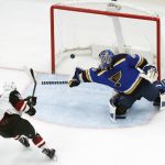 Arizona Coyotes' Brendan Perlini, left, scores past St. Louis Blues goalie Carter Hutton during the second period of an NHL hockey game Thursday, Nov. 9, 2017, in St. Louis. (AP Photo/Jeff Roberson)