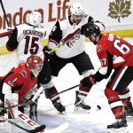 Ottawa Senators goaltender Mike Condon (1) and Ben Harpur (67) try to keep Arizona Coyotes' Christian Fischer (36) away from the puck as Coyotes' Brad Richardson (15) crashes into the net during the second period of an NHL hockey game in Ottawa, Saturday, Nov. 18, 2017. (Justin Tang/The Canadian Press via AP)