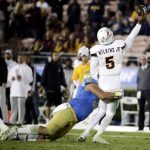 Arizona State quarterback Manny Wilkins, right, passes under pressure from UCLA defensive lineman Jacob Tuioti-Mariner during the second half of an NCAA college football game in Pasadena, Calif., Saturday, Nov. 11, 2017. UCLA won 44-37. (AP Photo/Chris Carlson)