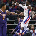 Detroit Pistons guard Reggie Jackson (1) passes the ball against Phoenix Suns forward Marquese Chriss (0) and center Greg Monroe during the first half of an NBA basketball game Wednesday, Nov. 29, 2017 in Detroit. Jackson led the Pistons with 23 points in a 131-107 win. (AP Photo/Duane Burleson)