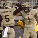 Arizona State quarterback Manny Wilkins (5) wide receiver N'Keal Harry (1) after a touchdown against Colorado during the first half of an NCAA college football game, Saturday, Nov. 4, 2017, in Tempe, Ariz. (AP Photo/Matt York)