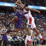 Phoenix Suns forward TJ Warren (12) is fouled by Washington Wizards guard Bradley Beal, right, during the second half of an NBA basketball game, Wednesday, Nov. 1, 2017, in Washington. The Suns won 122-116. (AP Photo/Nick Wass)