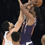 New York Knicks center Enes Kanter, left, gets a hand in the face of Phoenix Suns forward TJ Warren (12) during the first quarter of an NBA basketball game Friday, Nov. 3, 2017, at Madison Square Garden in New York. (AP Photo/Bill Kostroun)