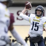 Northern Arizona quarterback Case Cookus (15) throws a pass against Montana in the first quarter of an NCAA college football game Saturday, Nov. 4, 2017, in Missoula, Mont. (AP Photo/Patrick Record)