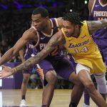 Phoenix Suns forward TJ Warren, left, and Los Angeles Lakers forward Brandon Ingram reach for a loose ball during the first half of an NBA basketball game, Friday, Nov. 17, 2017, in Los Angeles. (AP Photo/Mark J. Terrill)
