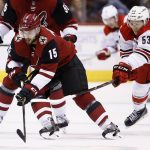Arizona Coyotes center Brad Richardson (15) skates with the puck in front of Carolina Hurricanes left wing Jeff Skinner (53) during the first period of an NHL hockey game Saturday, Nov. 4, 2017, in Glendale, Ariz. (AP Photo/Ross D. Franklin)
