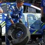 A blown-out tire is removed from the car driven by Jimmie Johnson in the garage during a NASCAR Cup Series auto race at Phoenix International Raceway Sunday, Nov. 12, 2017, in Avondale, Ariz. (AP Photo/Ross D. Franklin)
