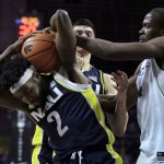 Northern Arizona forward Corey Brown (2) is fouled by Kansas State forward Makol Mawien, right, during the second half of an NCAA college basketball game in Manhattan, Kan., Monday, Nov. 20, 2017. (AP Photo/Orlin Wagner)