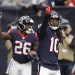 Houston Texans wide receiver DeAndre Hopkins (10) celebrates a touchdown catch by teammate Lamar Miller (26) during the first half of an NFL football game against the Arizona Cardinals, Sunday, Nov. 19, 2017, in Houston. (AP Photo/David J. Phillip)