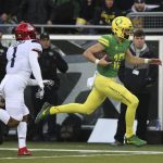 Oregon's quarterback Justin Herbert, right, rushes for the end zone ahead of Arizona's Tony Fields II for a touchdown during the first quarter of an NCAA college football game, Saturday, Nov. 18, 2017, in Eugene, Ore. (AP Photo/Chris Pietsch)