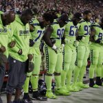 Members of the Seattle Seahawks bow during the national anthem prior to an NFL football game against the Arizona Cardinals, Thursday, Nov. 9, 2017, in Glendale, Ariz. (AP Photo/Rick Scuteri)