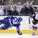 Toronto Maple Leafs center Auston Matthews (34) loses his stick as he's hit by Arizona Coyotes left wing Anthony Duclair (10) during third period NHL hockey action in Toronto on Monday, Nov. 20, 2017. (Nathan Denette/The Canadian Press via AP)