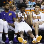 Phoenix Suns center Alex Len, from left, guard Troy Daniels, forward Josh Jackson and guard Devin Booker sit on the bench in the closing moments of a loss to the Brooklyn Nets during the second half of an NBA basketball game Monday, Nov. 6, 2017, in Phoenix. The Nets defeated the Suns 98-92. (AP Photo/Ross D. Franklin)