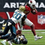Arizona Cardinals wide receiver Larry Fitzgerald (11) is hit by Jacksonville Jaguars cornerback Jalen Ramsey (20) and cornerback Aaron Colvin (22) during the first half of an NFL football game, Sunday, Nov. 26, 2017, in Glendale, Ariz. (AP Photo/Ross D. Franklin)