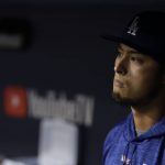 Los Angeles Dodgers' Yu Darvish watches from the dugout during the eighth inning of Game 7 of baseball's World Series against the Houston Astros Wednesday, Nov. 1, 2017, in Los Angeles. (AP Photo/Matt Slocum)