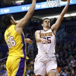 Phoenix Suns forward Dragan Bender, right, drives past Los Angeles Lakers center Andrew Bogut (66) to score during the second half of an NBA basketball game Monday, Nov. 13, 2017, in Phoenix. The Lakers won 100-93. (AP Photo/Ross D. Franklin)