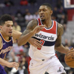 Washington Wizards guard Bradley Beal (3) dribbles against Phoenix Suns guard Devin Booker (1) during the first half of an NBA basketball game, Wednesday, Nov. 1, 2017, in Washington. (AP Photo/Nick Wass)