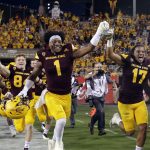 Arizona State wide receiver N'Keal Harry (1) and defensive back J'Marcus Rhodes (17) celebrate with the Territorial Cup after Arizona State defeated Arizona 42-30 during an NCAA college football game, Saturday, Nov 25, 2017, in Tempe, Ariz. (AP Photo/Rick Scuteri)