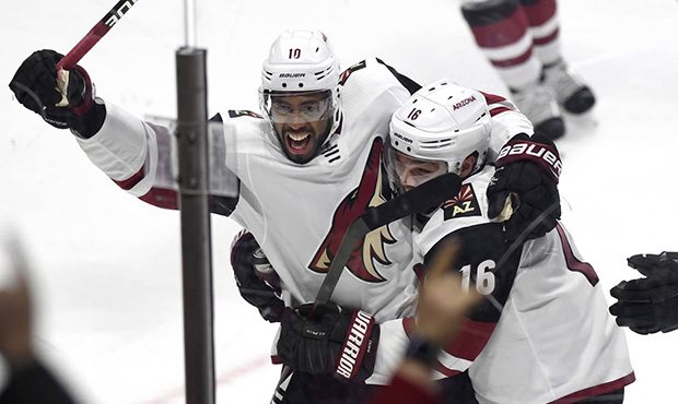 Arizona Coyotes' Anthony Duclair (10) celebrates with Max Domi (16) after scoring the game winning ...