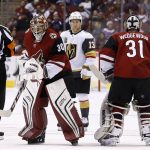 Arizona Coyotes goalie Marek Langhamer (30) skates past referee Trevor Hanson (14) as Langhamer replaces goalie Scott Wedgewood (31) as Vegas Golden Knights left wing Brendan Leipsic (13) and Coyotes center Nick Cousins (25) look on during the second period of an NHL hockey game Saturday, Nov. 25, 2017, in Glendale, Ariz. (AP Photo/Ross D. Franklin)