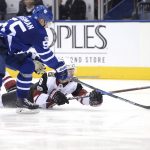 Arizona Coyotes center Clayton Keller (9) falls as he's checked by Toronto Maple Leafs defenseman Andreas Borgman (55) during third period NHL hockey action in Toronto on Monday, Nov. 20, 2017. (Nathan Denette/The Canadian Press via AP)