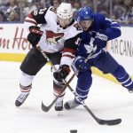 Toronto Maple Leafs center Zach Hyman (11) and Arizona Coyotes defenSeman Alex Goligoski (33) battle for the puck along the boards during second period NHL hockey action in Toronto on Monday, Nov. 20, 2017. (Nathan Denette/The Canadian Press via AP)