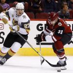 Vegas Golden Knights defenseman Shea Theodore (27) and Arizona Coyotes defenseman Alex Goligoski (33) battle for the puck during the second period of an NHL hockey game Saturday, Nov. 25, 2017, in Glendale, Ariz. (AP Photo/Ross D. Franklin)