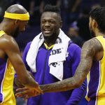 Los Angeles Lakers forwards Corey Brewer, left, Julius Randle, middle, and Brandon Ingram (14) celebrate in the closing moments of an NBA basketball game against the Phoenix Suns, Monday, Nov. 13, 2017, in Phoenix. The Lakers won 100-93. (AP Photo/Ross D. Franklin)