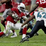 Arizona Cardinals running back Adrian Peterson (23) tries to avoid Jacksonville Jaguars strong safety Barry Church (42) during the second half of an NFL football game, Sunday, Nov. 26, 2017, in Glendale, Ariz. (AP Photo/Rick Scuteri)