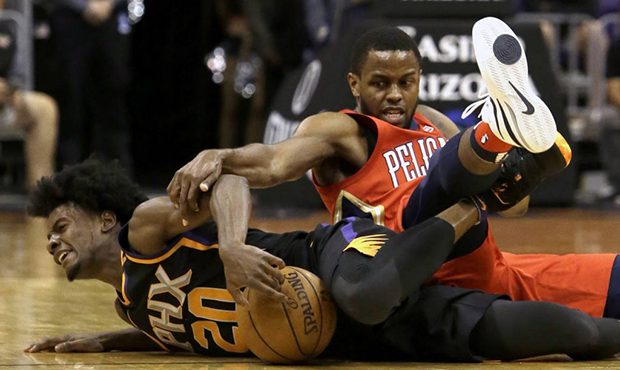 Phoenix Suns forward Josh Jackson (20) and New Orleans Pelicans forward Darius Miller battle for th...