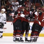 Arizona Coyotes defenseman Oliver Ekman-Larsson (23) celebrates his goal against the Los Angeles Kings with Clayton Keller, second from left, Brendan Perlini, center, Christian Fischer, second from right, and Derek Stepan (21) as Kings' Dustin Brown, left, skates past during the first period of an NHL hockey game Friday, Nov. 24, 2017, in Glendale, Ariz. (AP Photo/Ross D. Franklin)