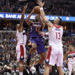 Phoenix Suns forward TJ Warren (12) goes to the basket against Washington Wizards center Marcin Gortat (13), of Poland, and guard Bradley Beal (3) during the second half of an NBA basketball game, Wednesday, Nov. 1, 2017, in Washington. The Suns won 122-116. (AP Photo/Nick Wass)