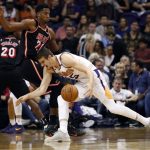 Phoenix Suns forward Dragan Bender (35) loses the ball as Miami Heat center Hassan Whiteside (21) defends during the first half of an NBA basketball game, Wednesday, Nov. 8, 2017, in Phoenix. (AP Photo/Matt York)