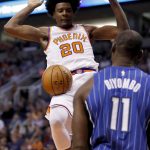 Phoenix Suns forward Josh Jackson (20) dunks as Orlando Magic center Bismack Biyombo (11) looks on during the second half of an NBA basketball game, Friday, Nov. 10, 2017, in Phoenix. (AP Photo/Matt York)