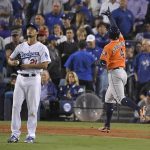 Houston Astros' George Springer, right, celebrates after his two-run home run off Los Angeles Dodgers starting pitcher Yu Darvish, of Japan, during the second inning of Game 7 of baseball's World Series Wednesday, Nov. 1, 2017, in Los Angeles. (AP Photo/Mark J. Terrill)