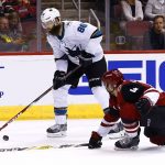 San Jose Sharks defenseman Brent Burns (88) looks to shoot the puck as Arizona Coyotes defenseman Niklas Hjalmarsson (4) slides in to defend during the first period of an NHL hockey game Wednesday, Nov. 22, 2017, in Glendale, Ariz. (AP Photo/Ross D. Franklin)