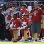 
              San Francisco 49ers outside linebacker Eli Harold, bottom center, and safety Eric Reid, bottom right, kneel during the national anthem before an NFL football game against the Arizona Cardinals in Santa Clara, Calif., Sunday, Nov. 5, 2017. (AP Photo/Jeff Chiu)
            