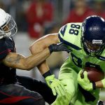Seattle Seahawks tight end Jimmy Graham (88) catches a touchdown pass as Arizona Cardinals strong safety Tyvon Branch (27) defends during the first half of an NFL football game, Thursday, Nov. 9, 2017, in Glendale, Ariz. (AP Photo/Ross D. Franklin)