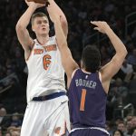 New York Knicks forward Kristaps Porzingis (6) shoots over Phoenix Suns guard Devin Booker (1) during the second quarter of an NBA basketball game Friday, Nov. 3, 2017, at Madison Square Garden in New York. (AP Photo/Bill Kostroun)