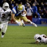 UCLA running back Giovanni Gentosi dives between Arizona State linebacker Christian Sam, left, and defensive back Cody French during the second half of an NCAA college football game in Pasadena, Calif., Saturday, Nov. 11, 2017. UCLA won 44-37. (AP Photo/Chris Carlson)