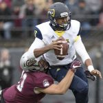 Northern Arizona quarterback Stone Smart, top, is sacked by Montana defensive end Chris Favoroso (43) in the first half of an NCAA college football game Saturday, Nov. 4, 2017, in Missoula, Mont. (AP Photo/Patrick Record)